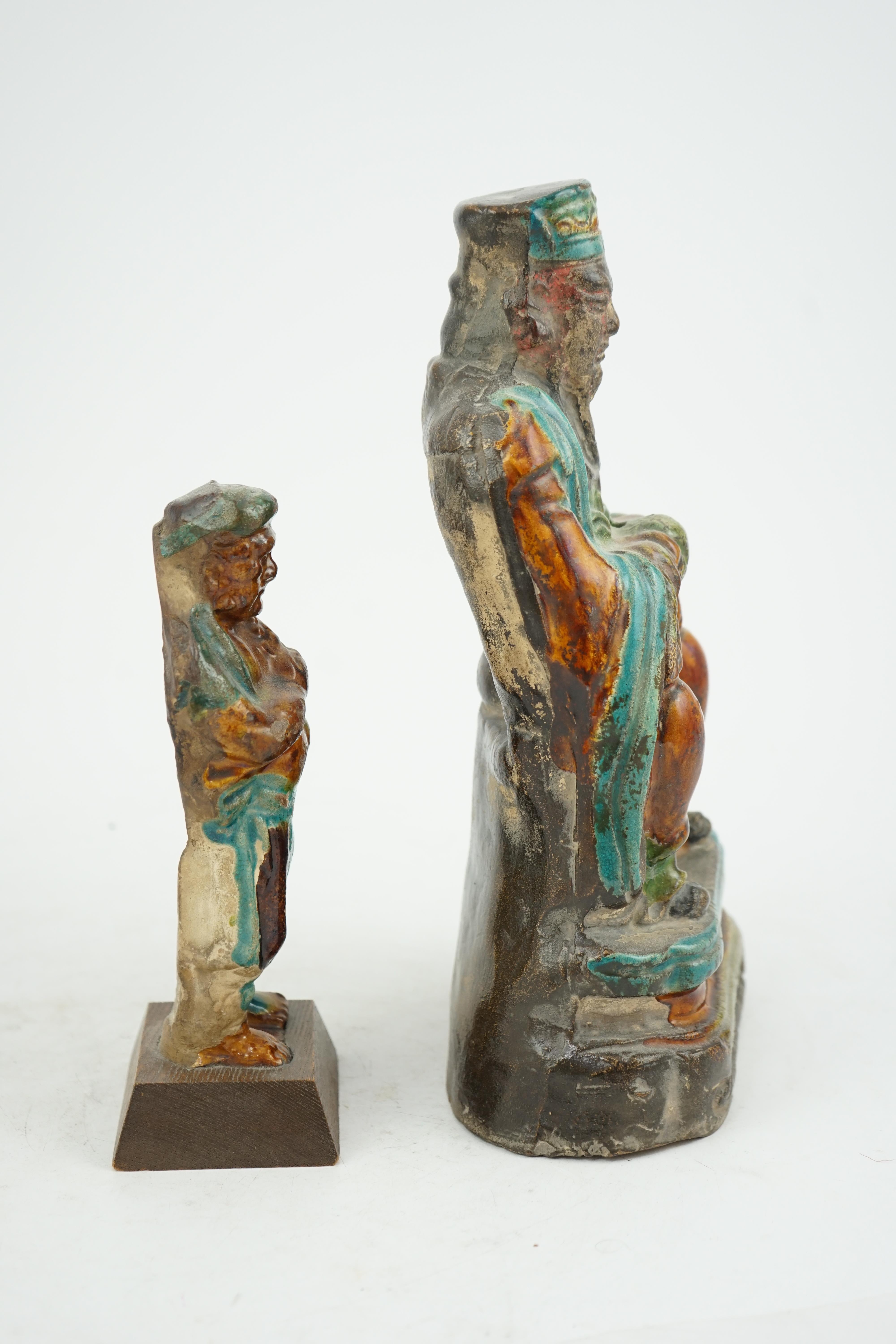 Two Chinese sancai glazed figures of a seated dignitary and a standing attendant, Ming dynasty